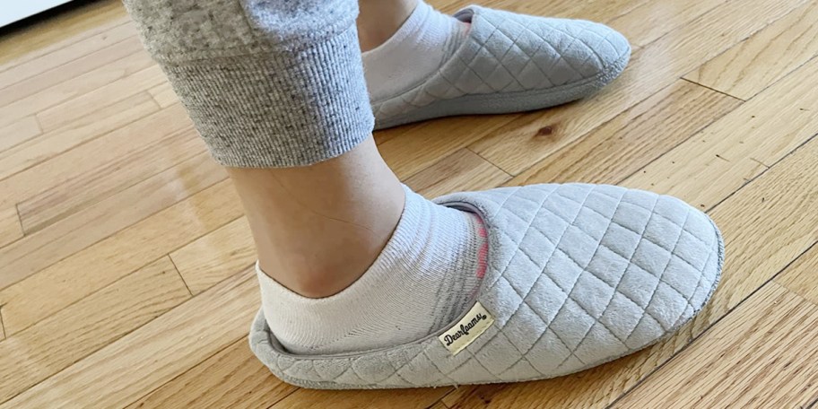 woman wearing gray slippers