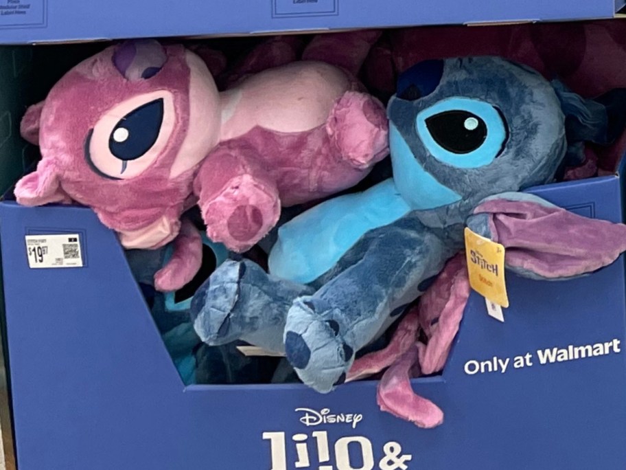 a bin with large Disney Stitch and Angel plushes