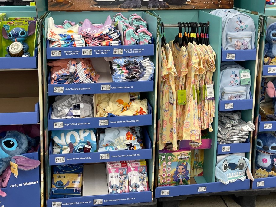 a Disney Lilo & Stitch display with clothing, tees, dresses, mini backpacks and more in Walmart
