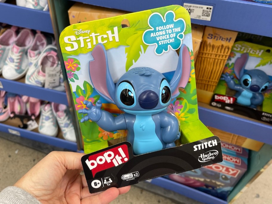 hand holding a Disney Stitch BopIt! game in Walmart