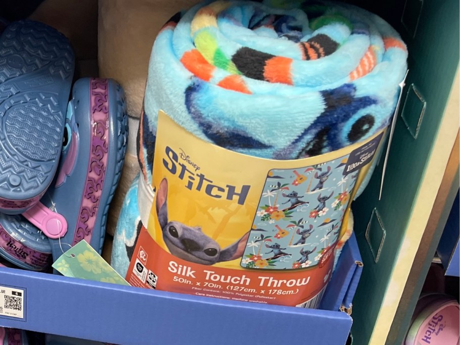 a Disney Stitch throw blanket on a store display