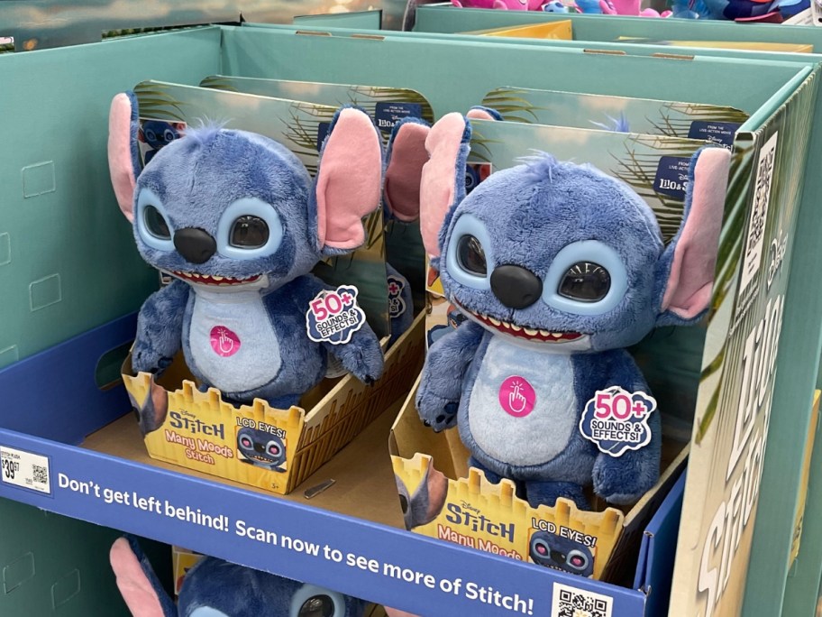 an interactive Disney Stitch plush in packaging on display at Walmart