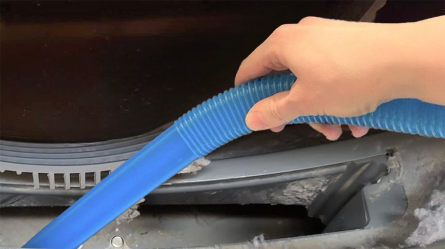 person using lint cleaner to clean a dryer vent
