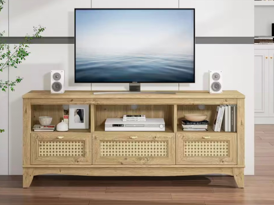 brown tv stand with tv on top 