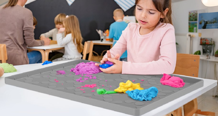 girl using under the sink mat with clay on it
