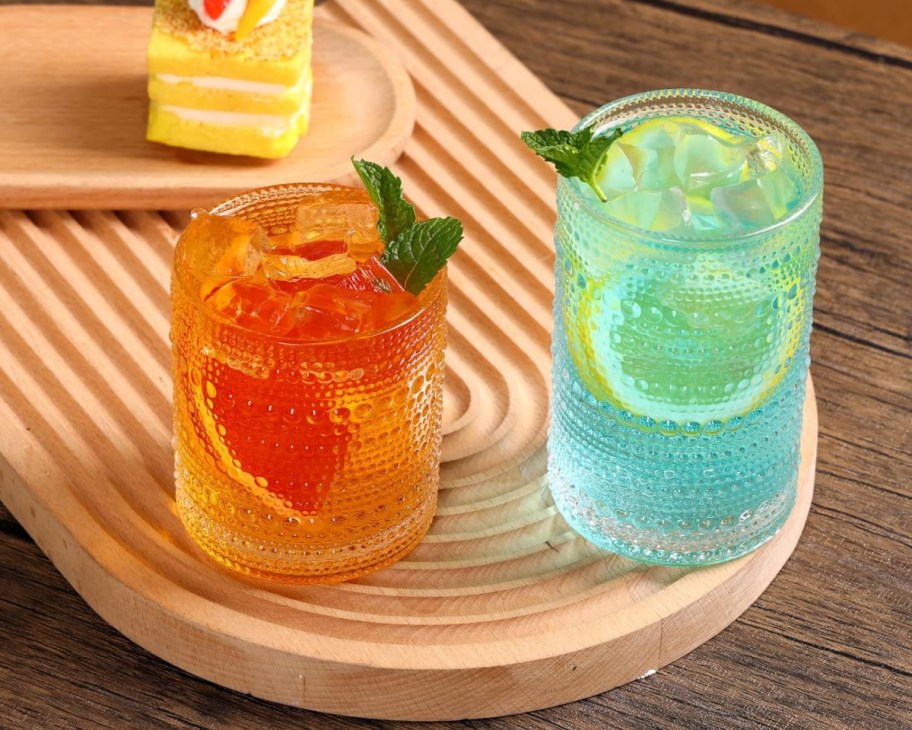 orange and blue drinks in hobnail glasses