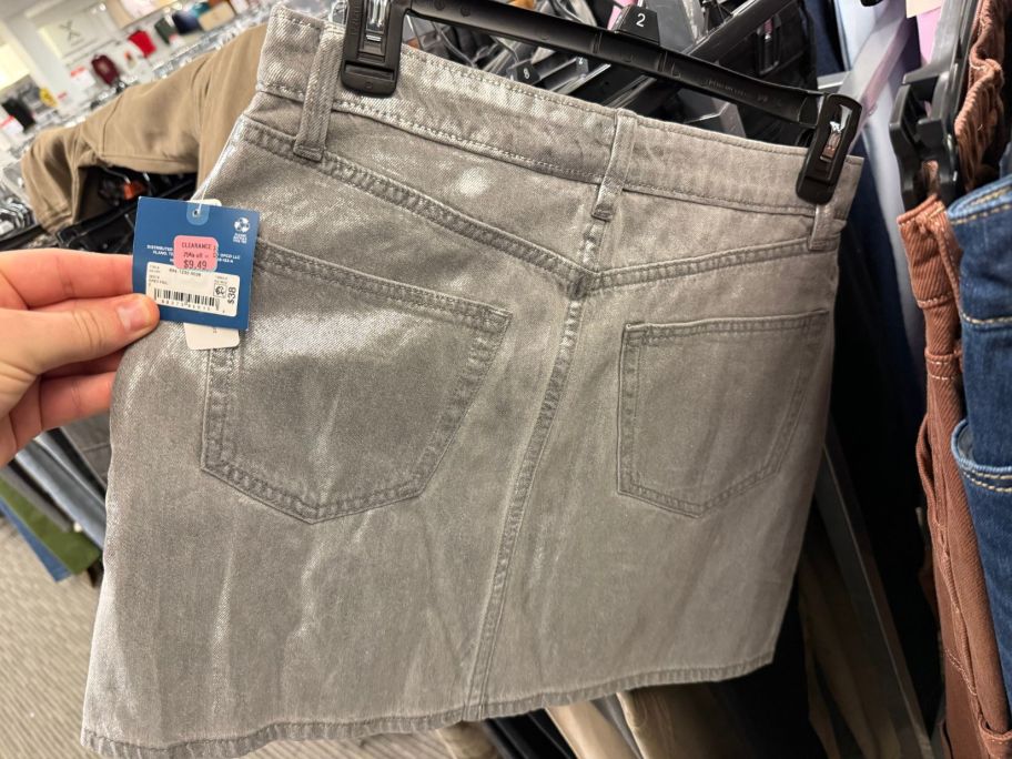 hand holding grey women's skirt in store