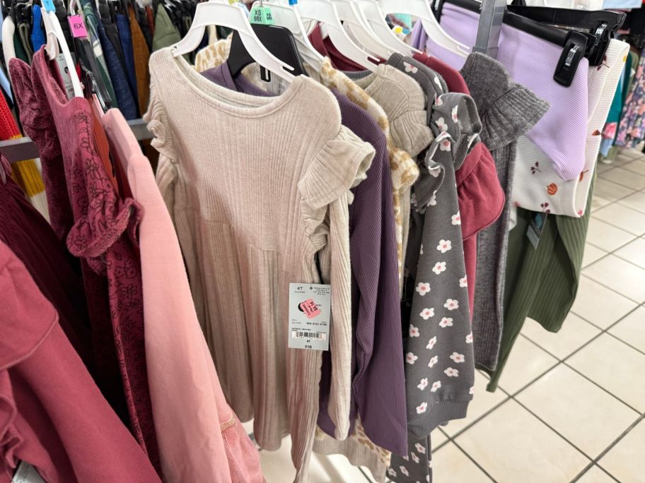 girls dresses hanging on rack in store