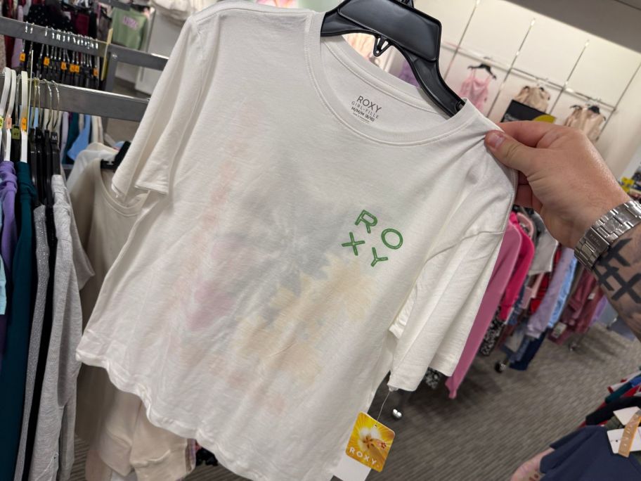 a white girls top in hand in store