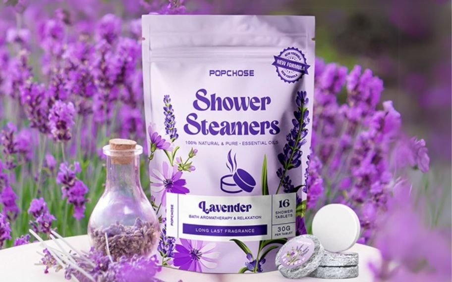 a bag of shower steamers arranged with lavender flower and essential oils