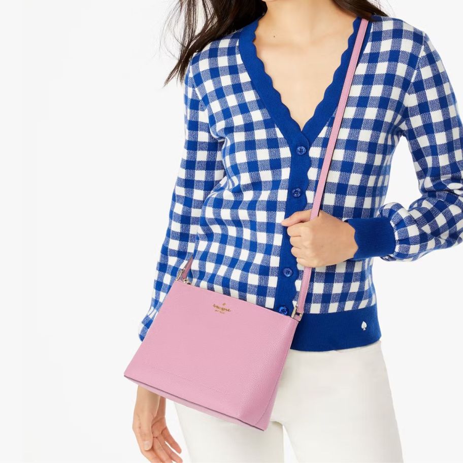 a woman with a pink crossbody handbag