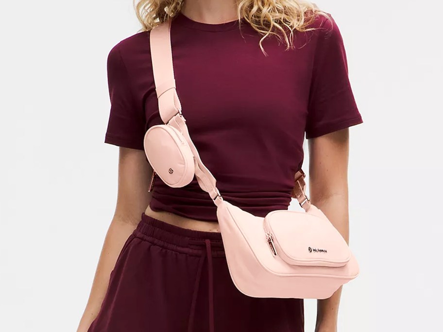 woman in a maroon outfit with a pink crossbody bag