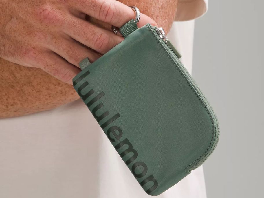 man holding lululemon Clippable Card Pouch