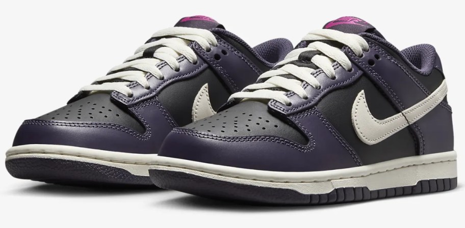 a pair of purple and white kid's Nike Dunk sneakers