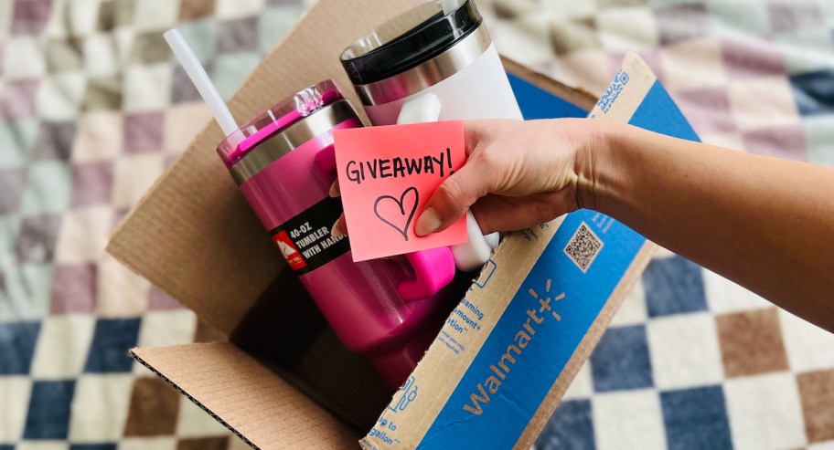 hand holding ozark trail tumblers from walmart box with giveaway post it note