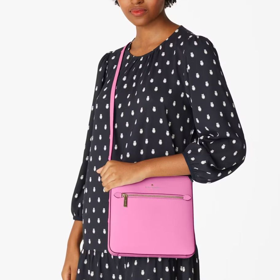 a woman with a pink crossbody handbag