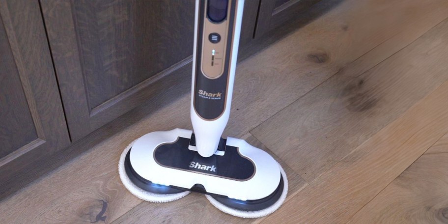 blue and white shark steam mop on floor 