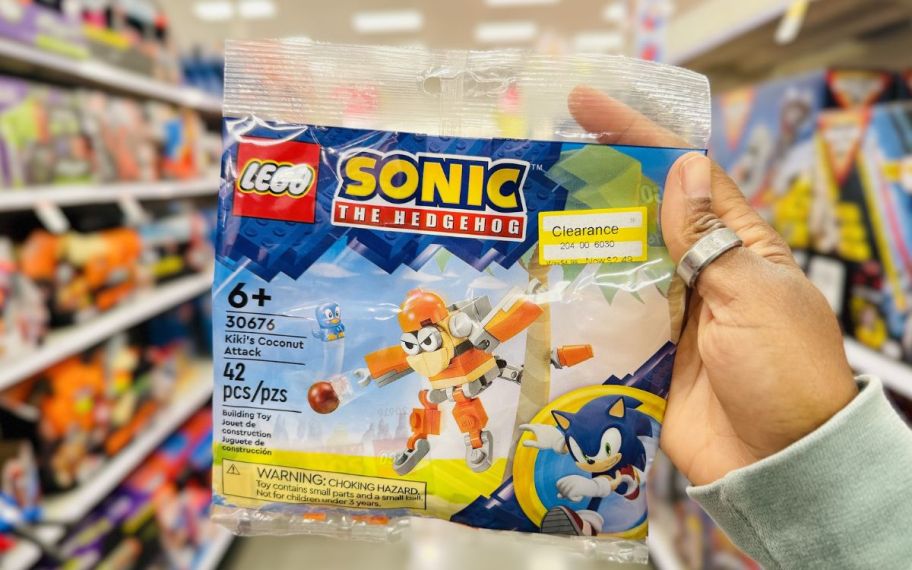 a womans hand holding a LEGO sonic hedgehog building toy