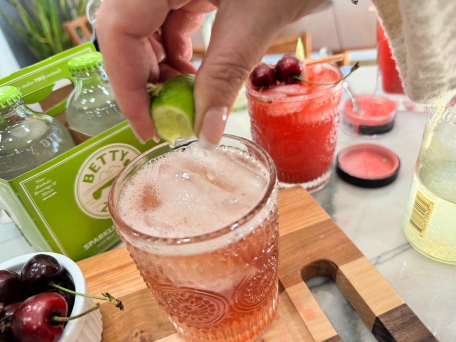 squeezing lime into a cup