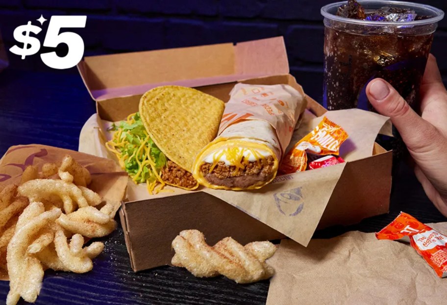 contents of Taco Bell Cravings box next to a fountain soda