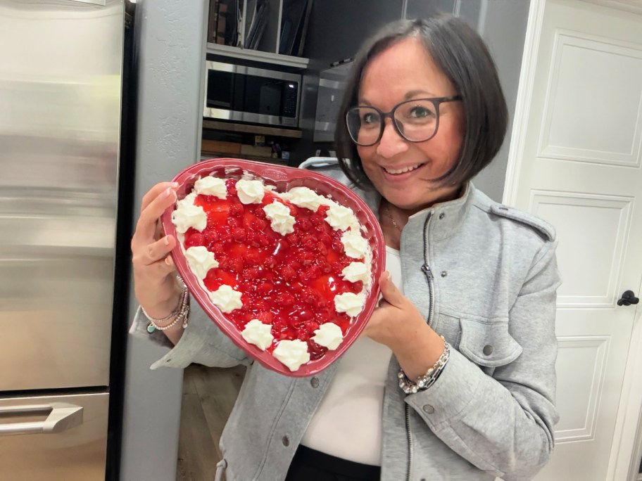 woman holding a heart shaped dessert for valentine's day 