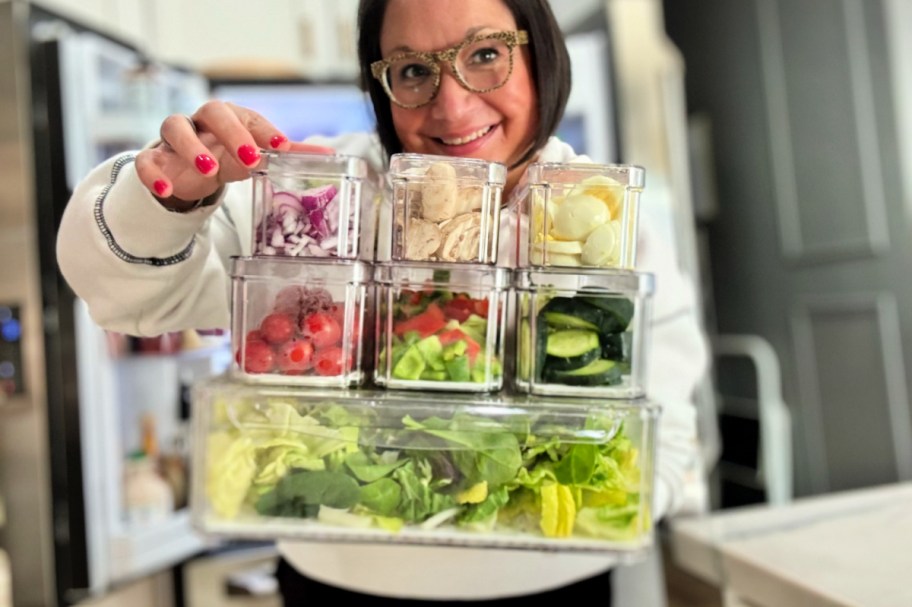 woman holding salad bar fridge prep containers