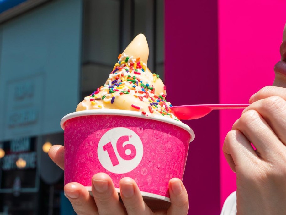 eating frozen yogurt with a pink spoon