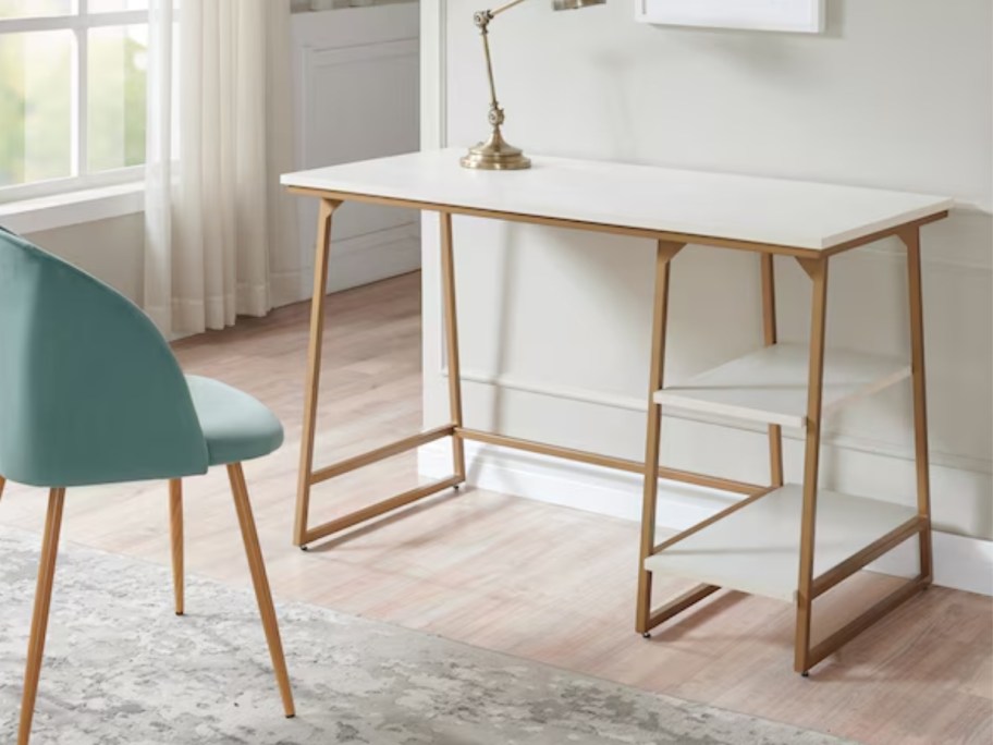 a white and gold metal desk with shelves in a home office