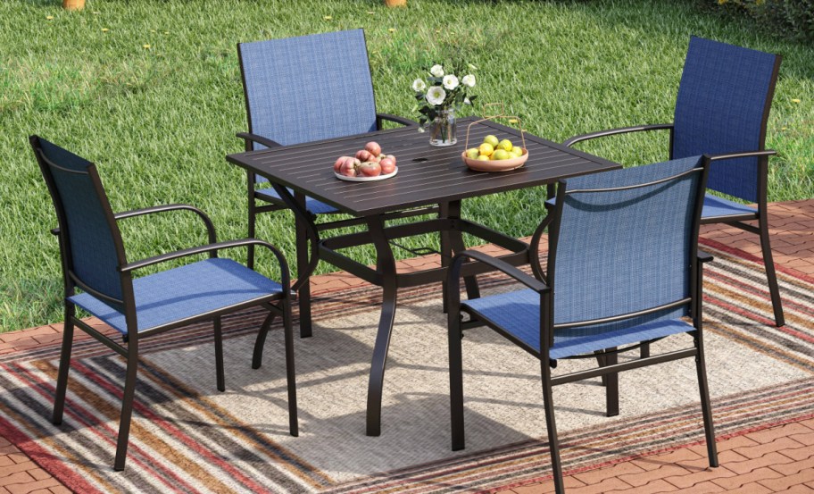 5 piece patio set displayed in the backyard with a. rug