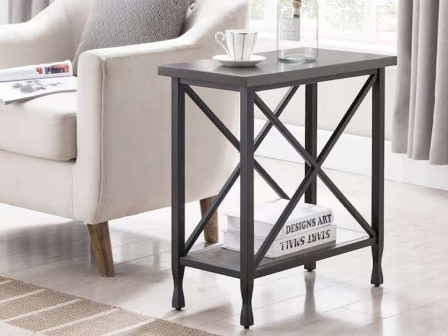 a dark brown modern style wood end table beside a white accent chair in a living room