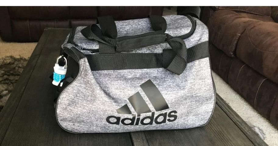 An adidas small deffel bag on a table