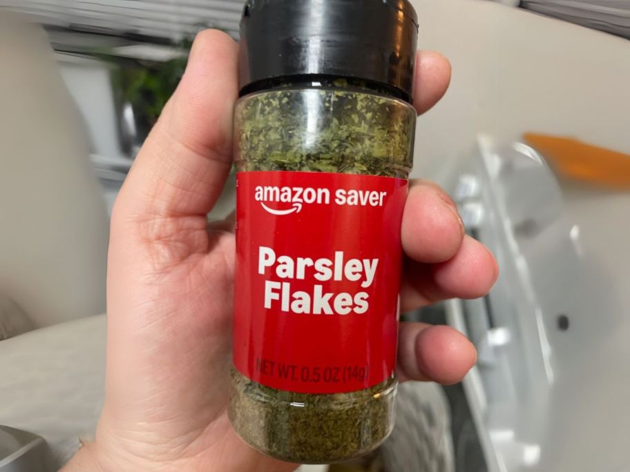 Amazon Saver Parsley Flakes 0.5oz in hand in kitchen