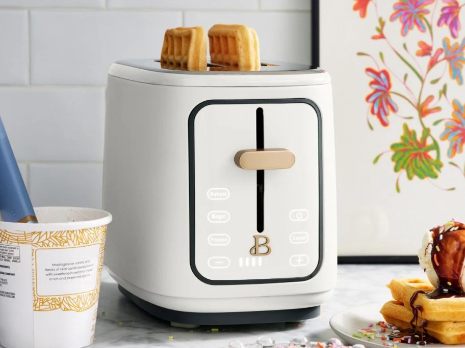 waffles inside a white and gold toaster