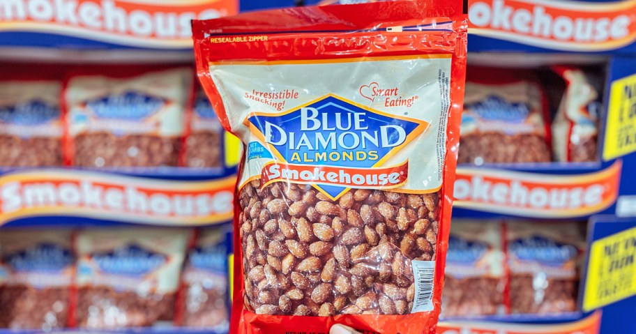 holding up a red bag of Blue Diamond Smokehouse Almonds