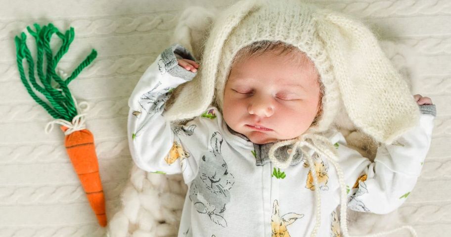 A sleeping baby wearing Burt's Bees bunny print pajamas