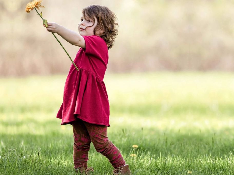 Little girl with a flower wearing Burt's Bees Valley Flowers Organic Baby Girl Set