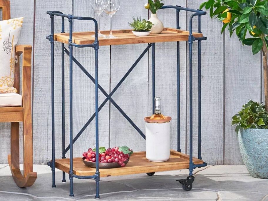 wood and metal bar cart on patio