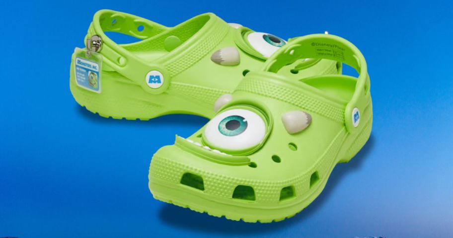 Crocs Monsters Inc. Mike Classic Clogs against blue background