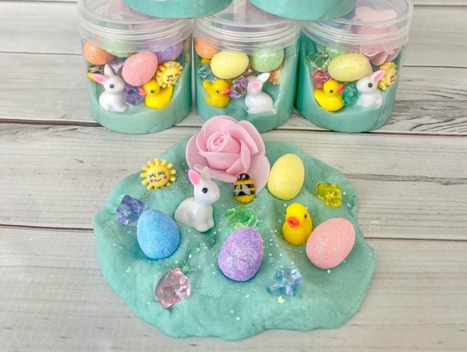 blue playdoh spread out on wood table with easter animals and eggs