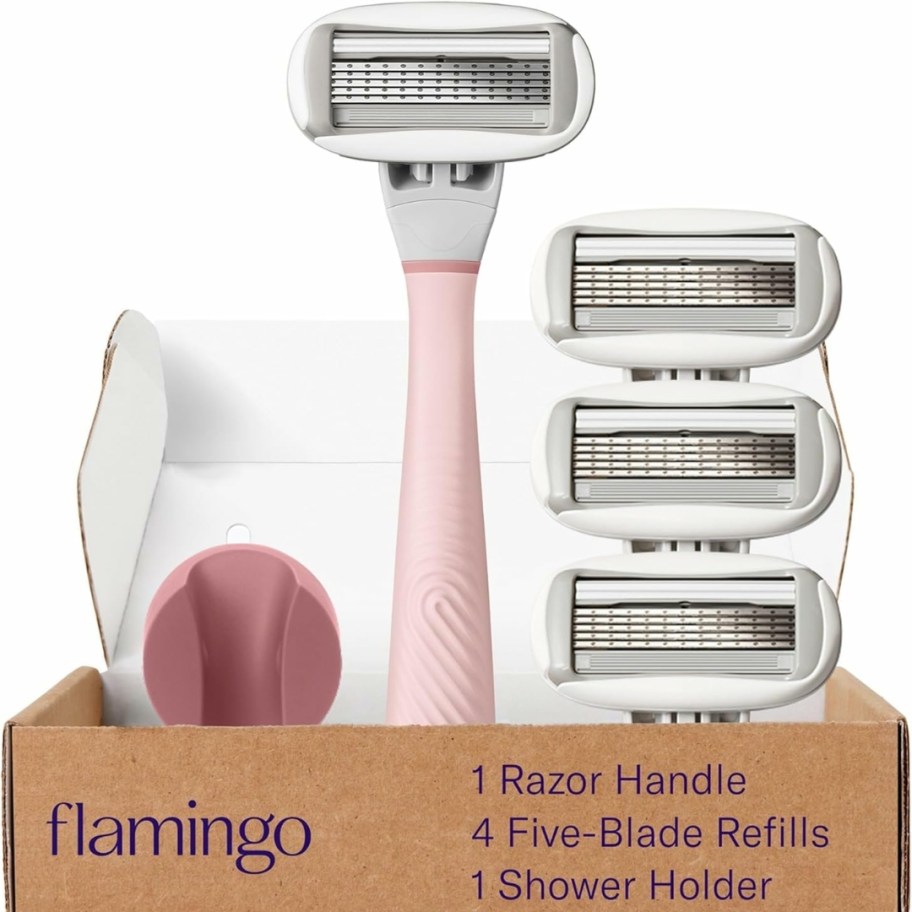 a pink Flamingo brand razor in a box with replacement blades and a shower holder