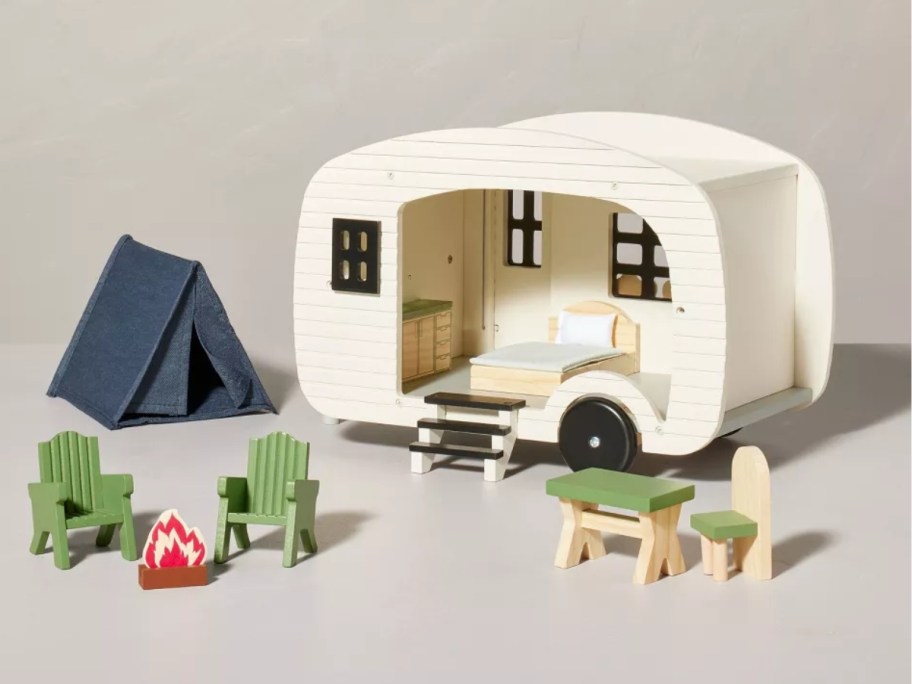 a wooden toy camper set with camper and accessories