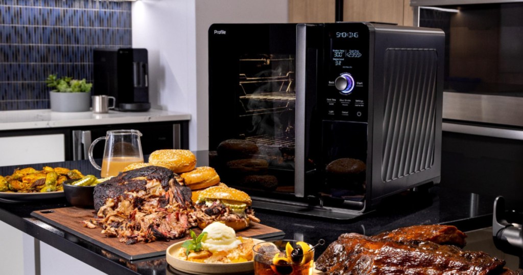 GE indoor smoker on kitchen countertop next to smoked meat platters