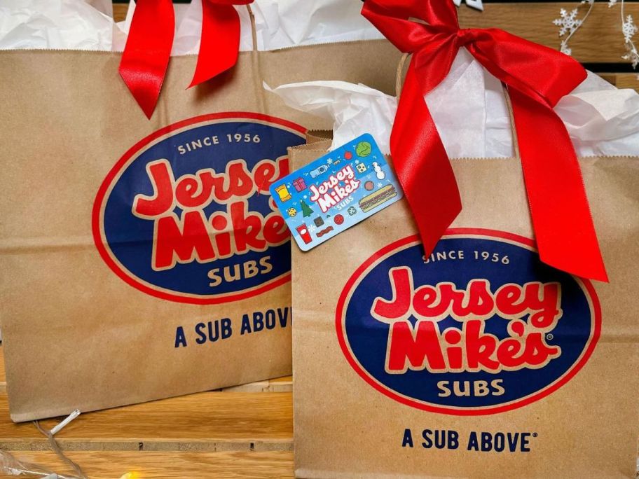 Bags of Jersey Mike's Food with qa gift card attached to it