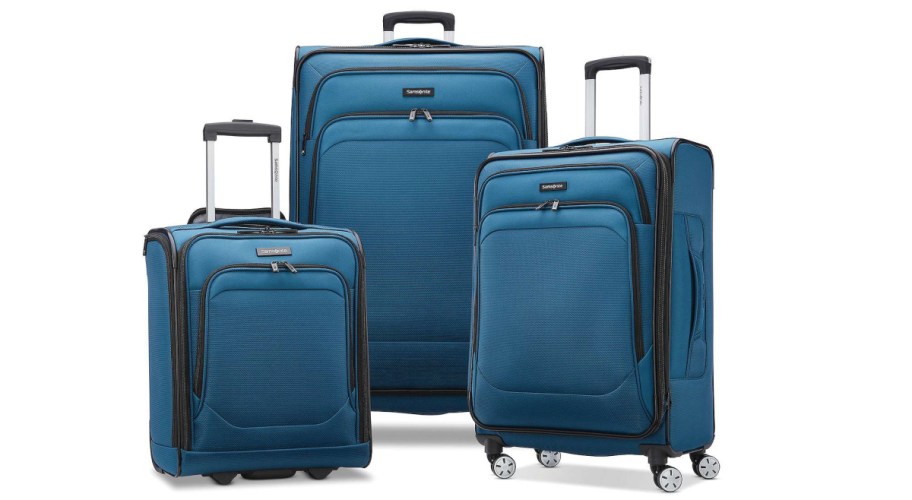 Three kohls luggages stacked in front of eachother in blue