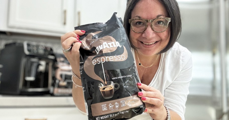 woman holding up a bag of Lavazza Espresso Whole Bean Coffee