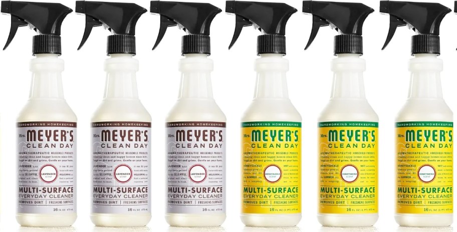 3 purple and 3 yellow bottles of Mrs. Meyer's Multi-Surface Everyday Cleaner Sprays