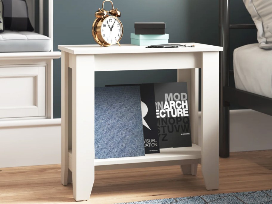 white wooden end table next to bed