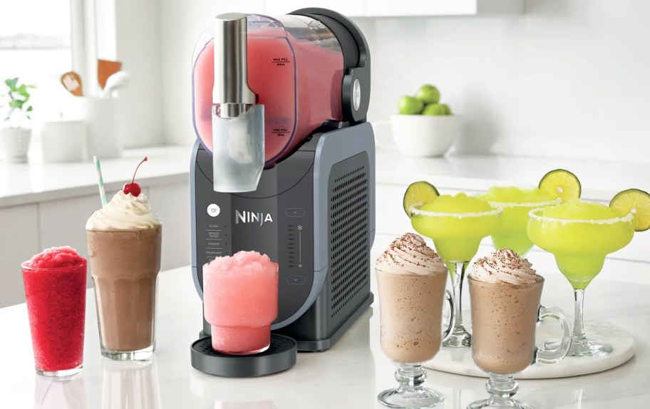 Ninja slushi maker with different drinks around it