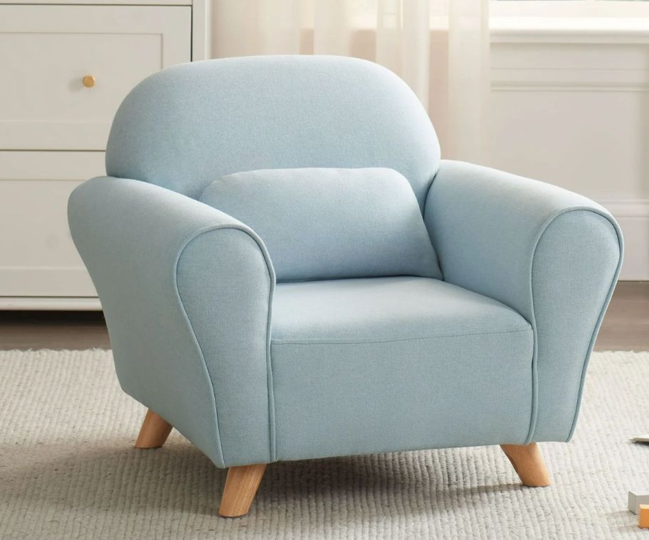 a light blue modern accent chair in a playroom