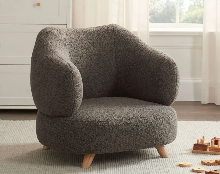 a CHOCOLATE BROWN modern accent chair in a playroom